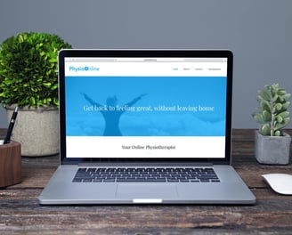 A laptop on a desk displaying the PhysioOnline website with a blue banner and white text.