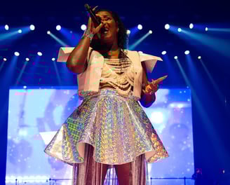 a woman in a white dress and a microphone
