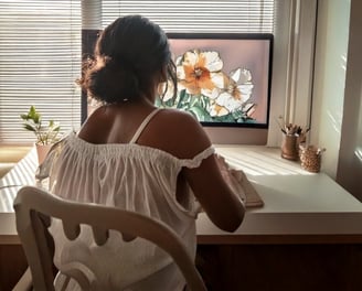 Black woman designing flower design on a computer