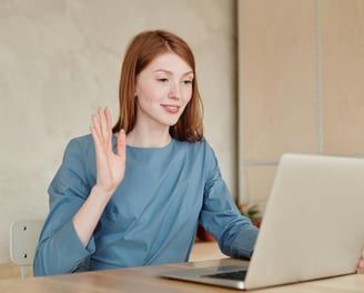 a woman sitting at a table with a laptop and attending customers of fix collision for insurance help