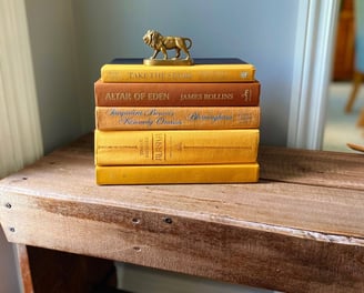a wooden table with books as counselling resources and a horse statue