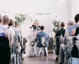 a bride and groom are sitting at the altar