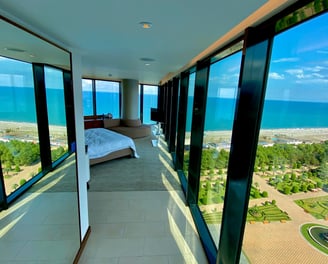 a bedroom with a bed and a view of the sea