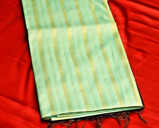 Elegant green Chanderi silk saree with golden stripes, perfect for festive and wedding occasions.