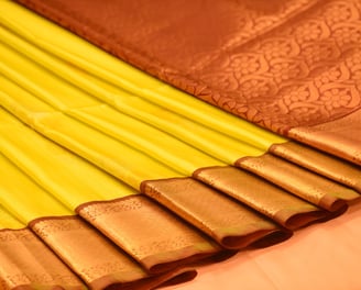 Elegant Kanjivaram silk saree in yellow with intricate golden zari work, ideal for special occasions