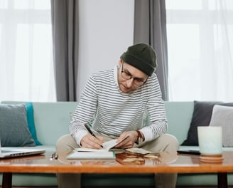 man working on a budget in his living room