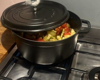 a potted potted with vegetables on a stove top
