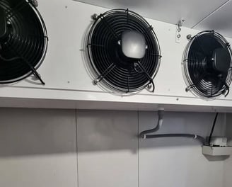 Massive industrial evaporators mounted on the ceiling of the cold room for high-capacity