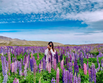a woman standing in a field of flowers