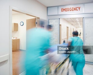 a group of medical workers walking through a hospital
