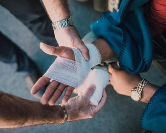 a man is holding a bandage in his hand