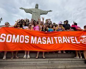 a group of people standing on steps with a large banner