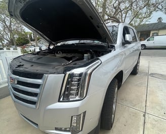 a silver truck with a hood up and a hood up