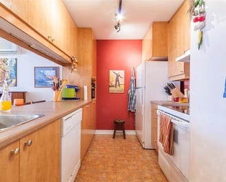 a kitchen with a sink, refrigerator, and stove