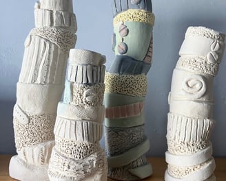 a group of ceramic sculptures vases