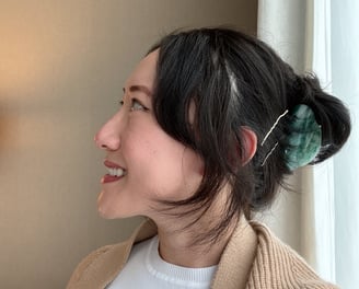 A photo of Yuko looking to the left and smiling