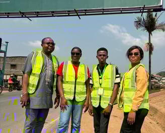 a group of people standing in front of a billboard