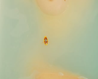 a person in a bathtub with a small boat in the water
