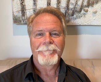 a man with a mustache and mustache mustaches on his face