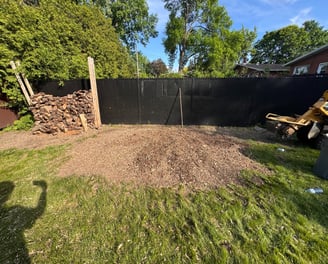 Stump removal in progress on a residential lawn in Saint-Lazare, restoring yard safety and appearanc