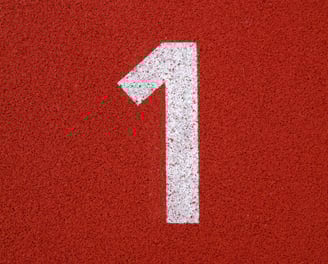 a number one on a red surface of a tennis court