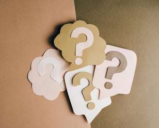 a group of question mark on a brown background