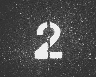 a number two on a street sign in the middle of a street