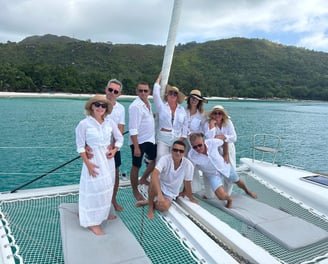 Family dressed in white posing on a catamaran - Catamaran Fishing Charters Seychelles