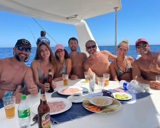 Happy family posing on a catamaran in the relaxation area - Catamaran Fishing Charters Seychelles