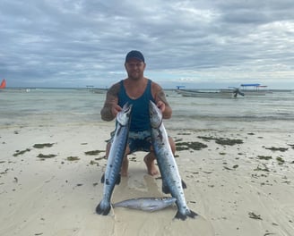 Angler holding an impressive Barracudas caught off the coast of Zanzibar