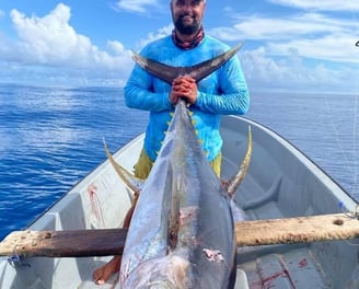 Zanzibar Fishing Trips – angler holding a massive Yellowfin Tuna on a fishing boat