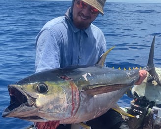 Angler holding a yellowfin tuna on a Catamaran Fishing Charter in Zanzibar