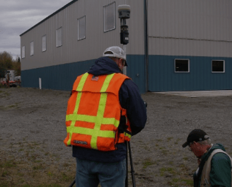 a man in a safety vest and a camera