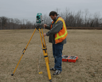 a man in a safety vest and a tripodod