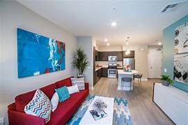 a living room with a red couch and a television