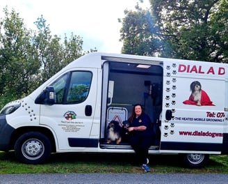 Suzy with her dog inside the custom build dial a dog wash van