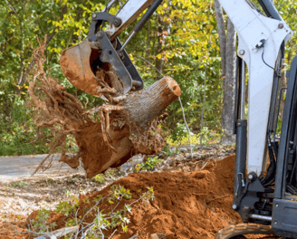 a man is taking a break from a tree stump removal