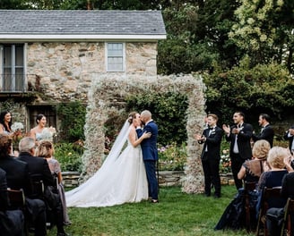 Couple kissing at alter in outdoor field