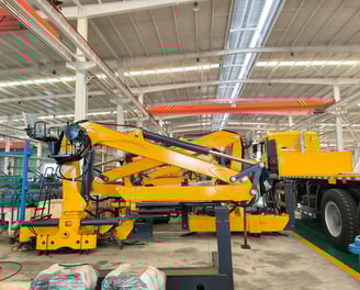 Factory snapshot: Yellow Q160LA2 knuckleboom log loader (timber crane for sale), custom-built for a client.