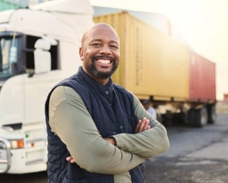 a man in a vest and vest standing in front of a truck