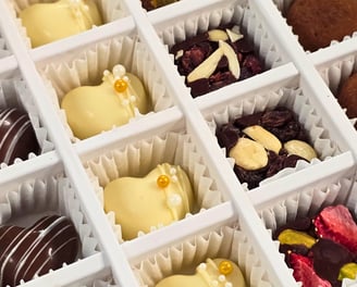 Gourmet Artisanal Assorted Chocolates including dark, milk, white chocolate, and truffles from Chocos Cookies Cakes