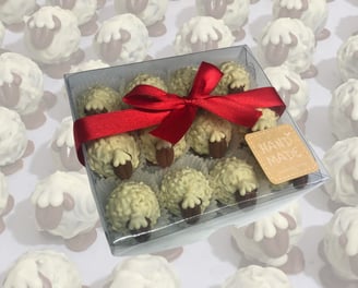 Assorted custom chocolate truffles in flavors like coffee, orange, Irish cream, and lavender, luxurious flavorful experience