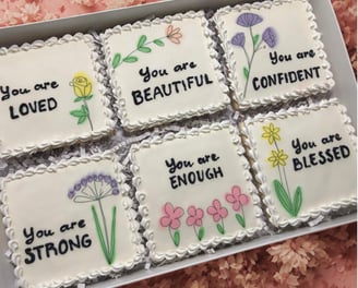 Gift box with beautifully decorated cookies with royal icing and uplifting messages like You are beautiful, strong, blessed