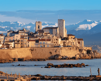 Antibes old town village on the sea with snowy mountains
