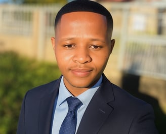 a man in a suit and tie standing in front of a fence