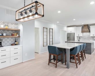 a kitchen with a marble counter top and a bar stool