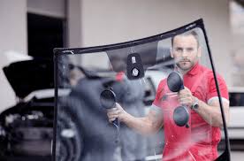 a man in a red shirt is holding a camera