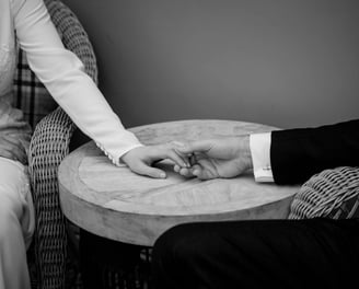 Black and White wedding photo of bride and groom holding hands