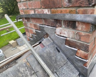 Repairs at Blable house near Wadebridge, Cornwall. Renewal of lead flashing around the chimney.