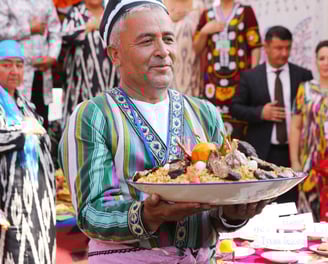 Uzbek Person is holding plov